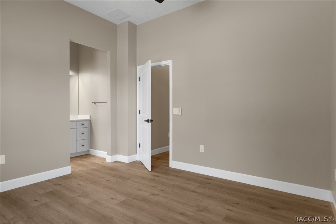 4530 South Florida Avenue Inverness, FL 34450 - Photo 30 of 100 a view of an empty room with wooden floor and a bathroom