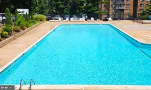 a view of swimming pool with a backyard and a slide