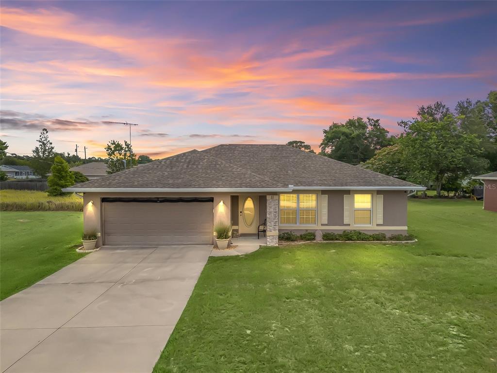 11 Pecan Course Loop Ocala, FL 34472 - Photo 1 of 1 a front view of a house with a yard and garage