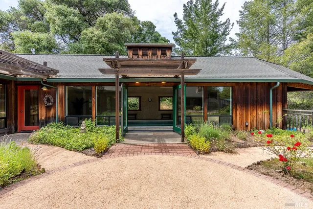 a large kitchen with kitchen island a sink stainless steel appliances and a counter top space