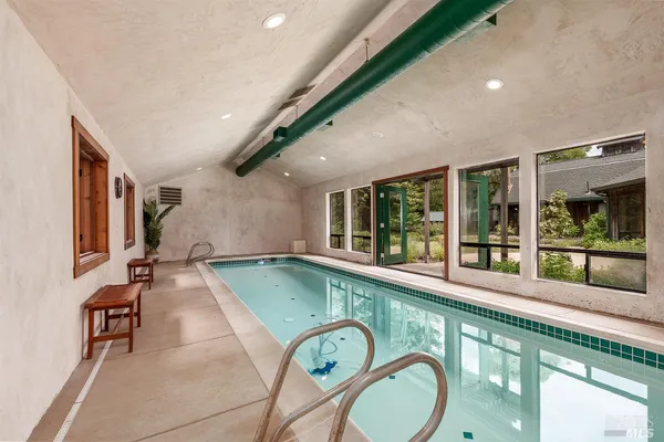 a swimming pool view with a seating space
