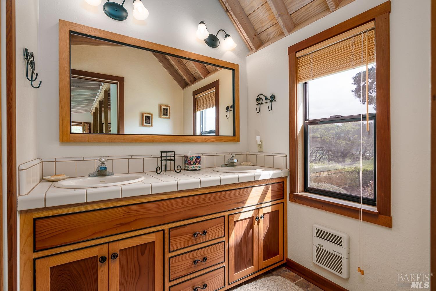 2151 Guntly Road Philo, CA 95466 - Photo 29 of 43 a bathroom with a sink a two mirror and a window