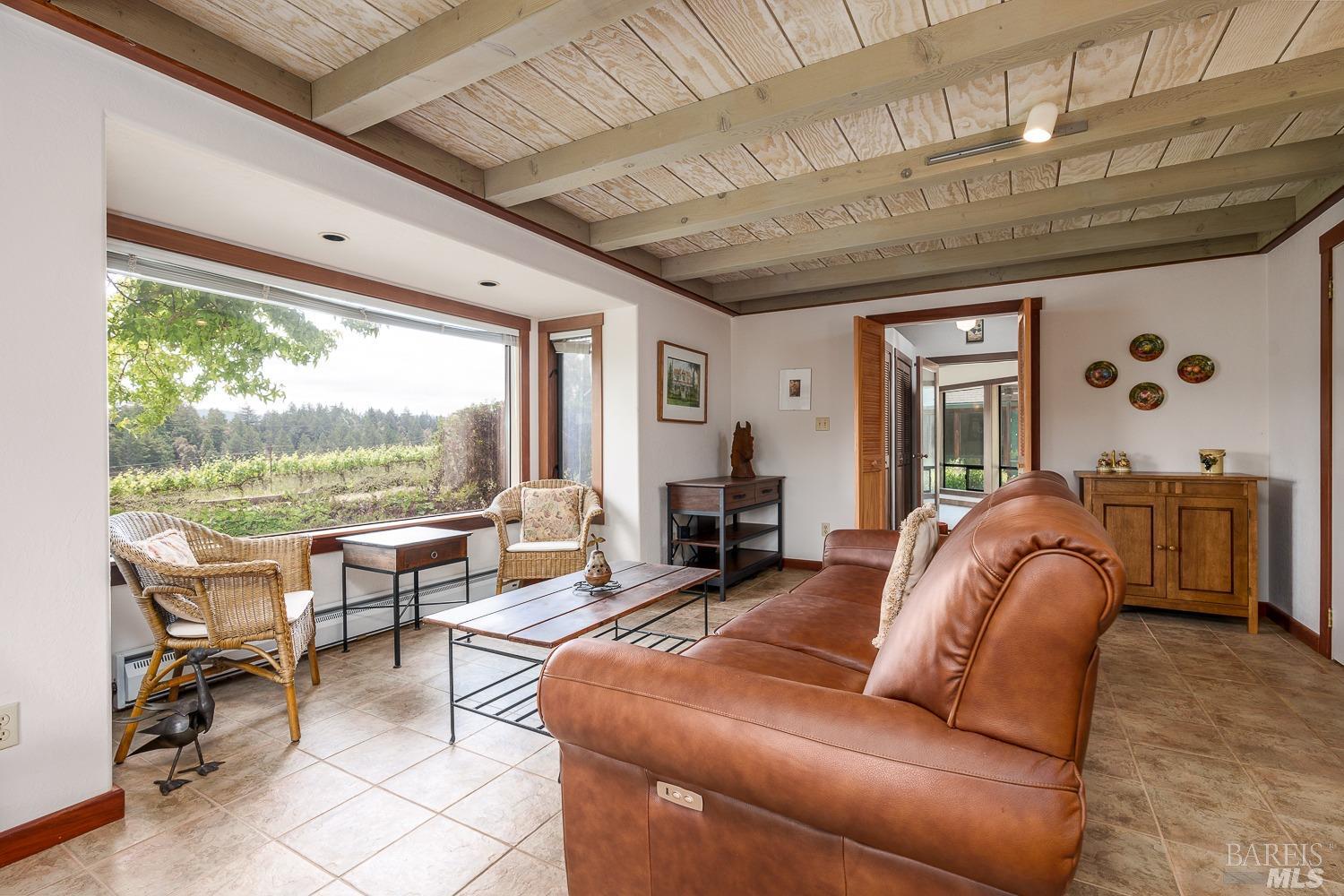2151 Guntly Road Philo, CA 95466 - Photo 7 of 43 a living room with furniture a window and a chandelier