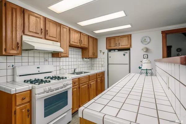 a kitchen with a stove a sink and a refrigerator