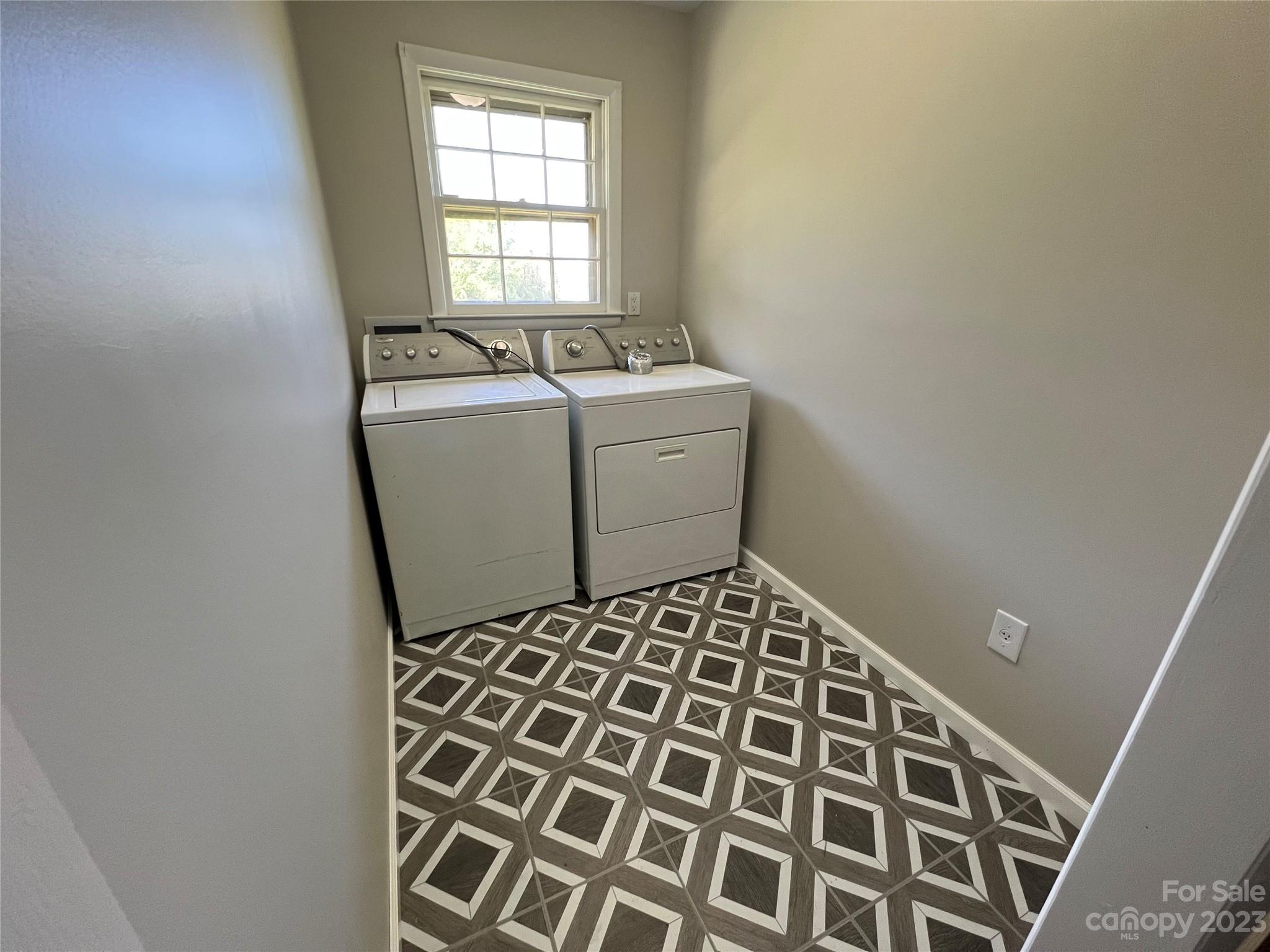 590 Hog Pen Branch Road Mooresboro, NC 28114 - Photo 13 of 36 a utility room with a sink a washer and dryer