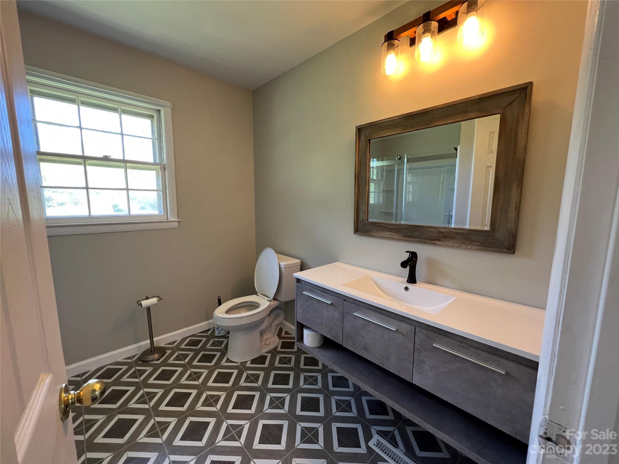 590 Hog Pen Branch Road Mooresboro, NC 28114 - Photo 14 of 36 a bathroom with a double vanity sink and a mirror