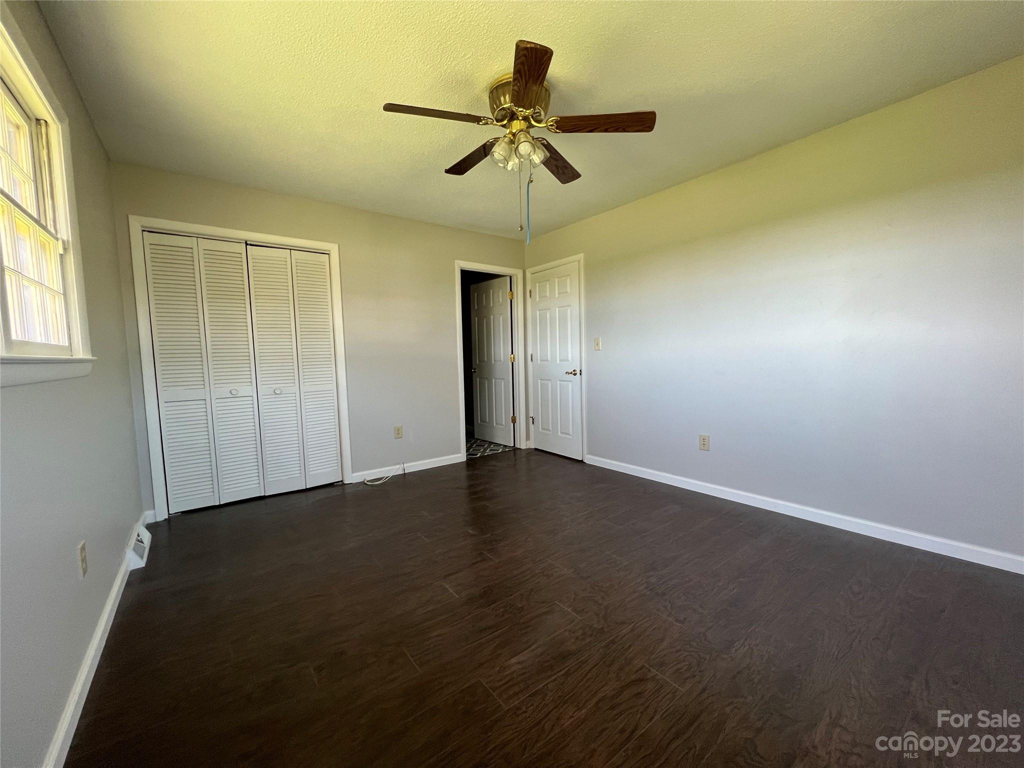 590 Hog Pen Branch Road Mooresboro, NC 28114 - Photo 18 of 36 an empty room with a ceiling fan and window