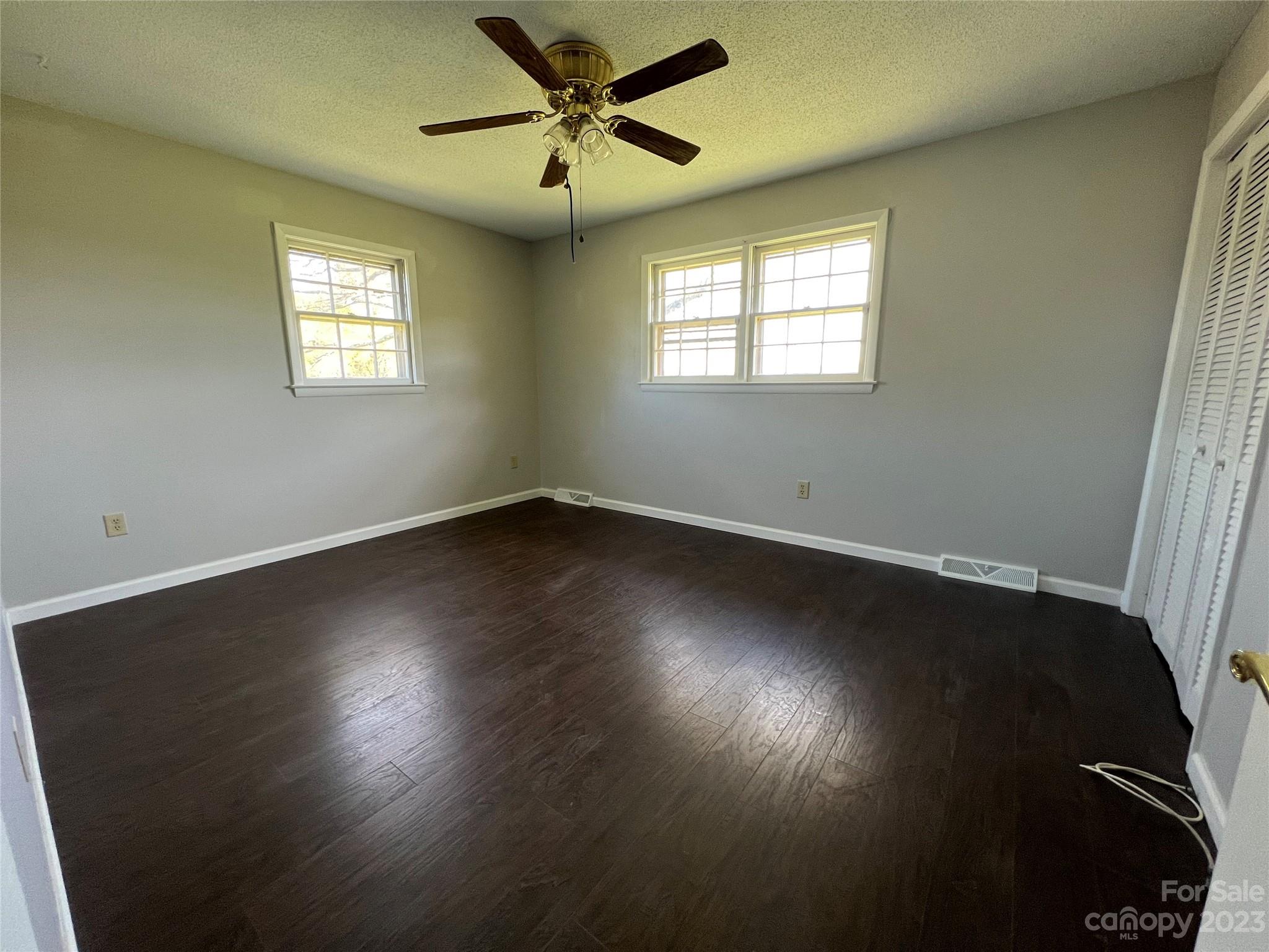 590 Hog Pen Branch Road Mooresboro, NC 28114 - Photo 19 of 36 a view of wooden floor and windows in a room