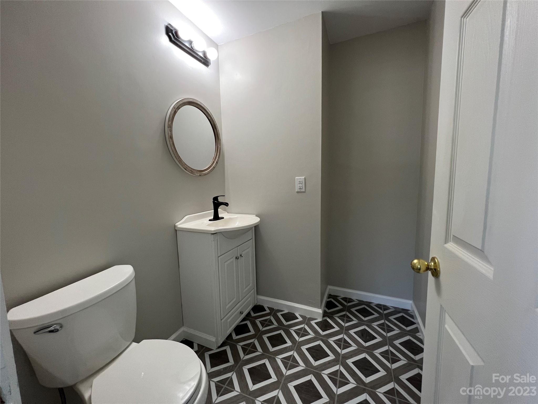 590 Hog Pen Branch Road Mooresboro, NC 28114 - Photo 20 of 36 a bathroom with a sink toilet and a mirror