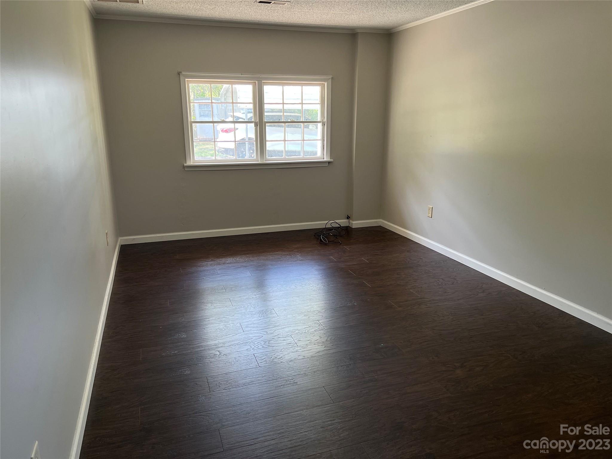 590 Hog Pen Branch Road Mooresboro, NC 28114 - Photo 22 of 36 an empty room with wooden floor and windows