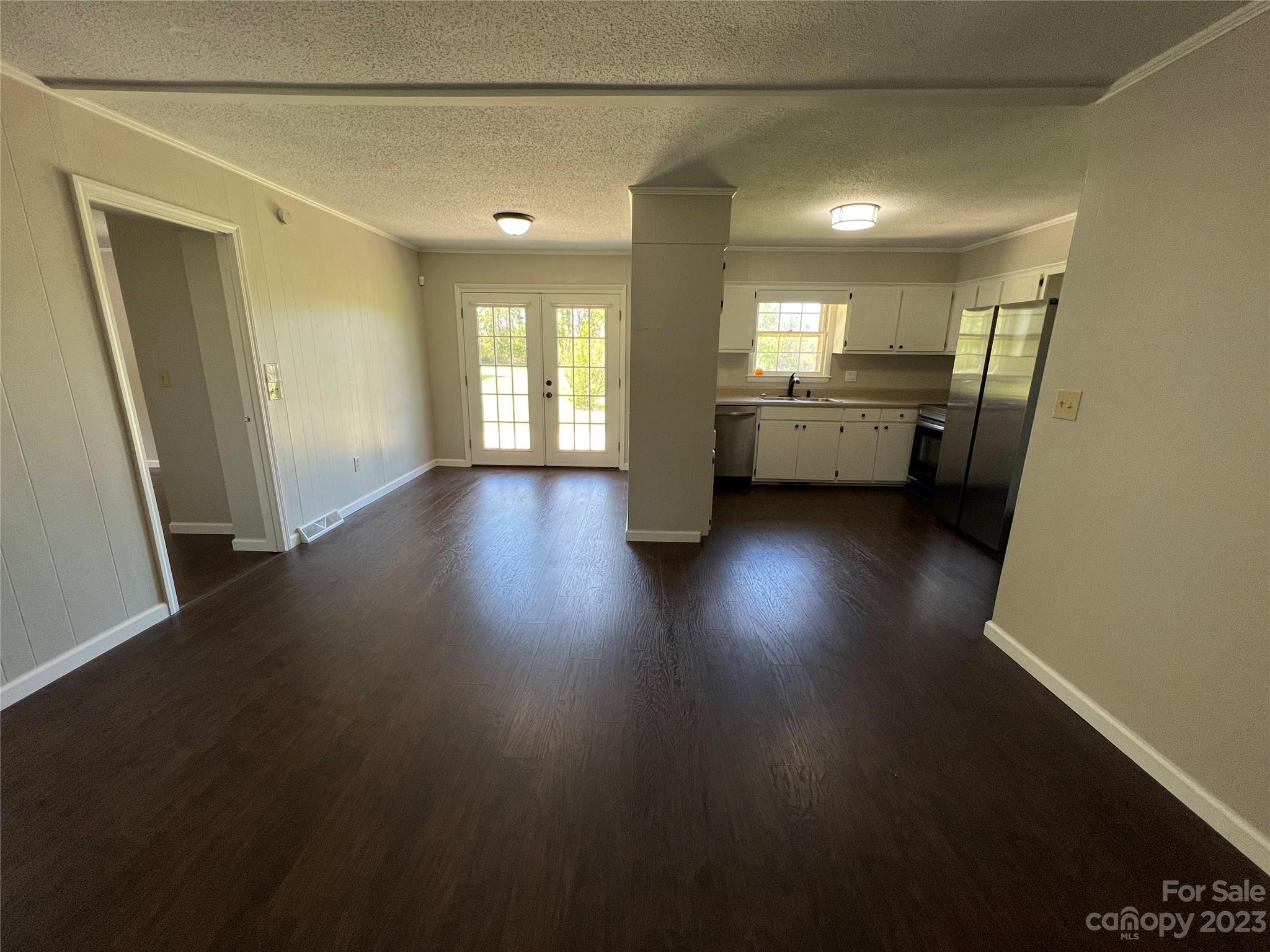 590 Hog Pen Branch Road Mooresboro, NC 28114 - Photo 8 of 36 a view of an empty room with wooden floor and a window