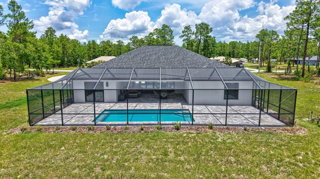 13362 Downy Woodpecker Road Weeki Wachee, FL 34614 - Photo 23 of 26 a view of a house with a yard