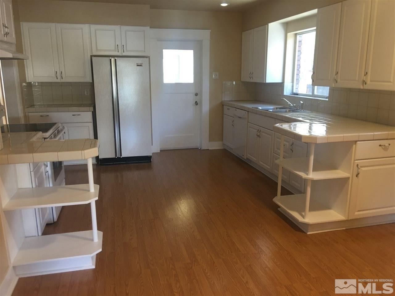 911 F Street Sparks, NV 89431 - Photo 4 of 15 a kitchen with stainless steel appliances granite countertop a refrigerator and a sink