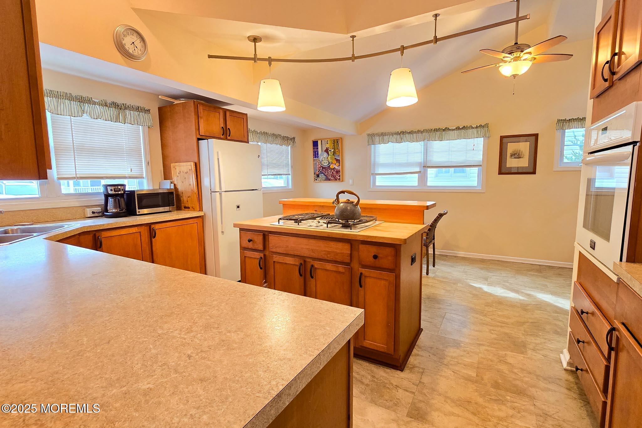 34 South Surf Road Lavallette, NJ 08735 - Photo 17 of 63 a kitchen with stainless steel appliances granite countertop a sink a stove and a refrigerator