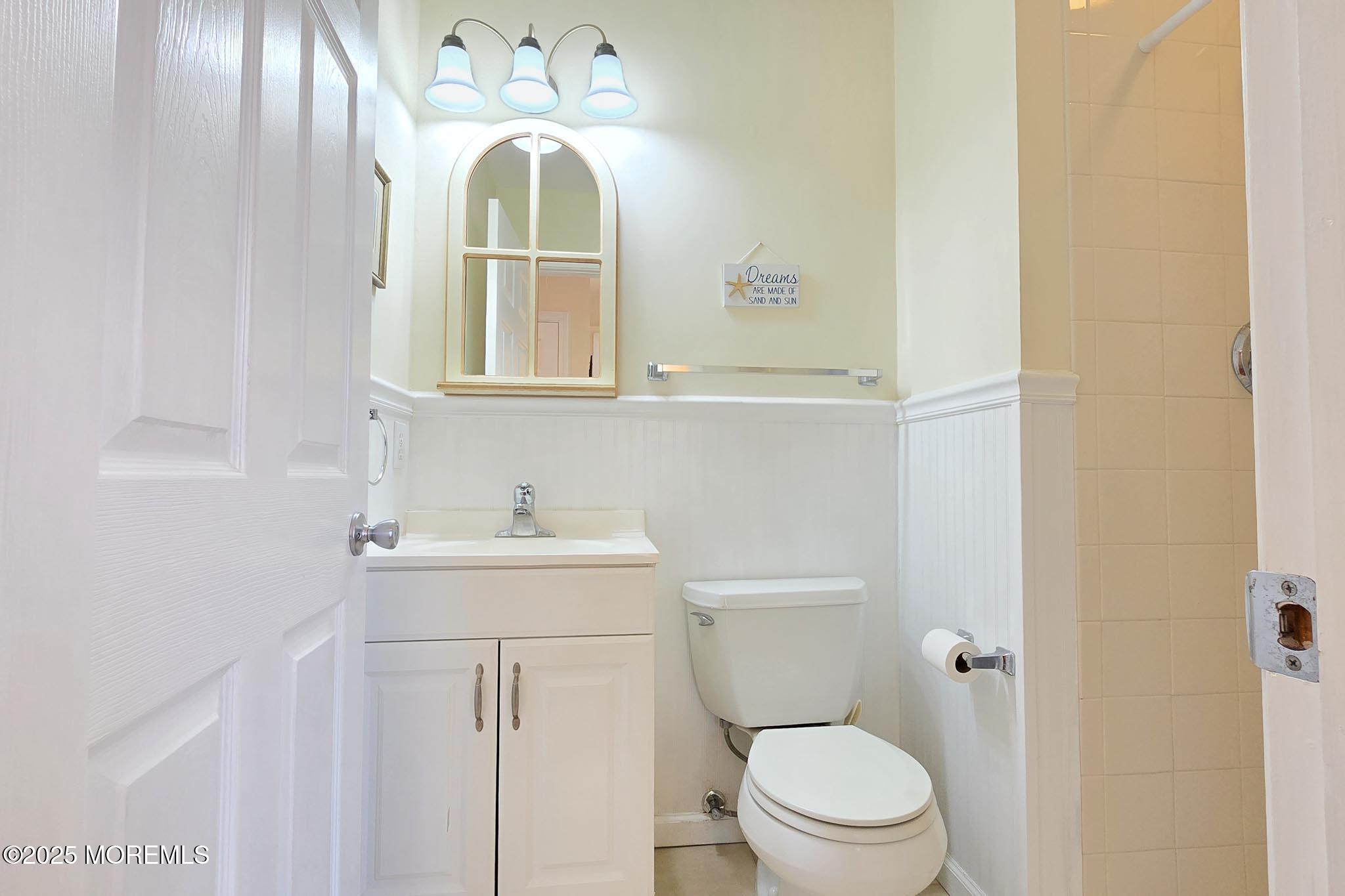34 South Surf Road Lavallette, NJ 08735 - Photo 36 of 63 a bathroom with a sink mirror vanity and toilet