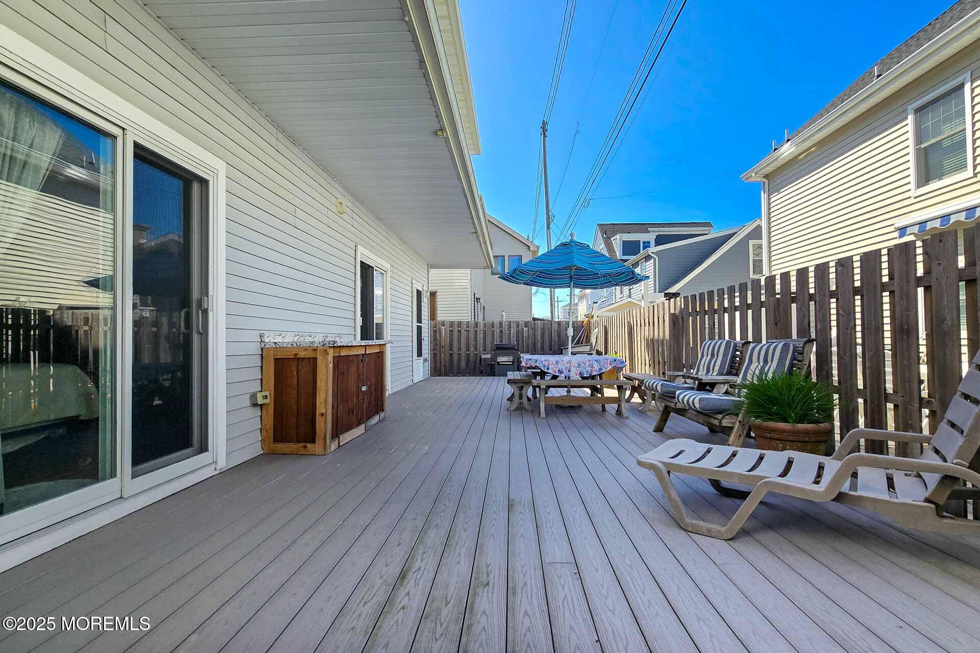 34 South Surf Road Lavallette, NJ 08735 - Photo 8 of 63 a view of a patio with table and chairs and wooden floor
