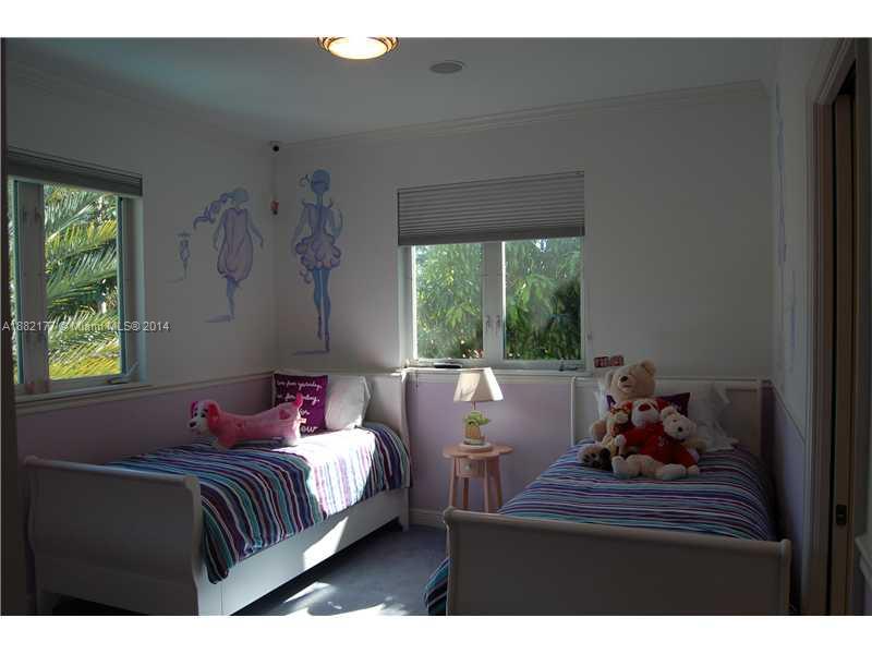 735 Southwest 22nd Road Miami, FL 33129 - Photo 13 of 14 a bedroom with a bed and wooden floor