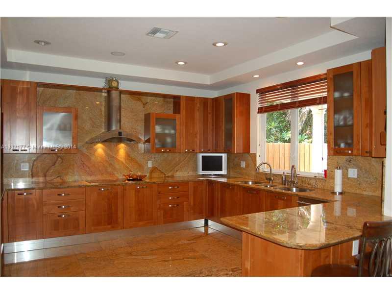 735 Southwest 22nd Road Miami, FL 33129 - Photo 2 of 14 a living room with kitchen island granite countertop furniture a sink and a large window