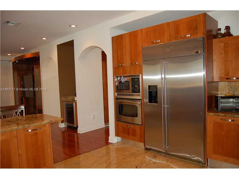 735 Southwest 22nd Road Miami, FL 33129 - Photo 3 of 14 a kitchen with refrigerator and car