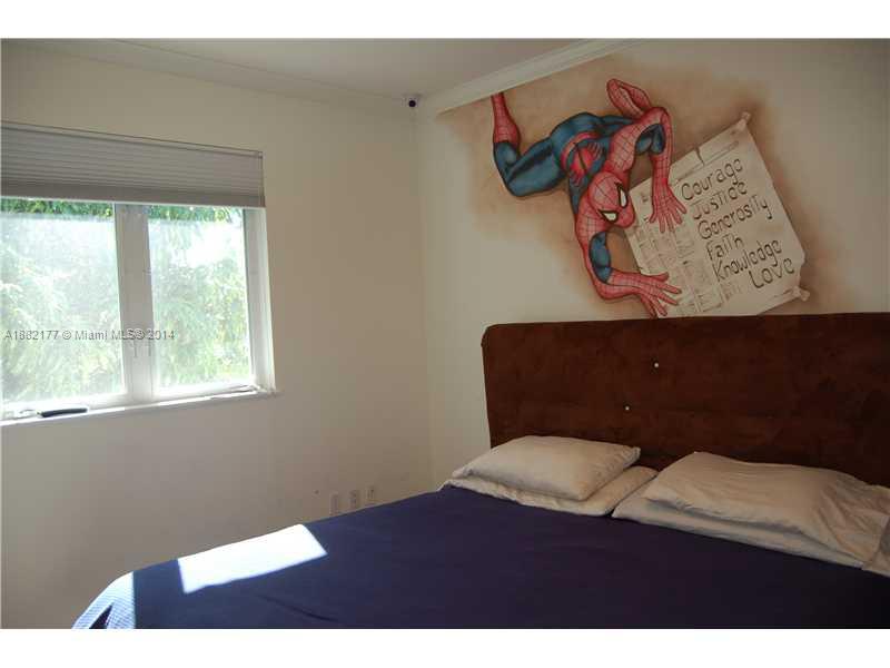 735 Southwest 22nd Road Miami, FL 33129 - Photo 10 of 14 a bedroom with a bed and furniture