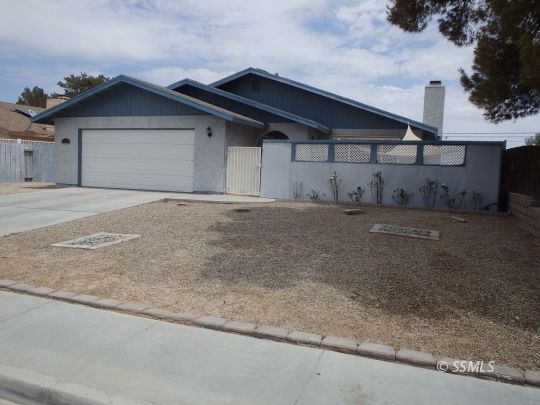 412 North Mono Street Ridgecrest, CA 93555 - Photo 3 of 50 a front view of a house with a garage