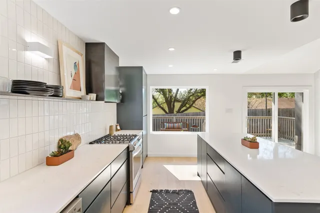 a kitchen with a sink and a stove top oven
