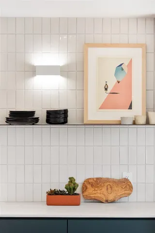 a room with a table chair and painting on the wall