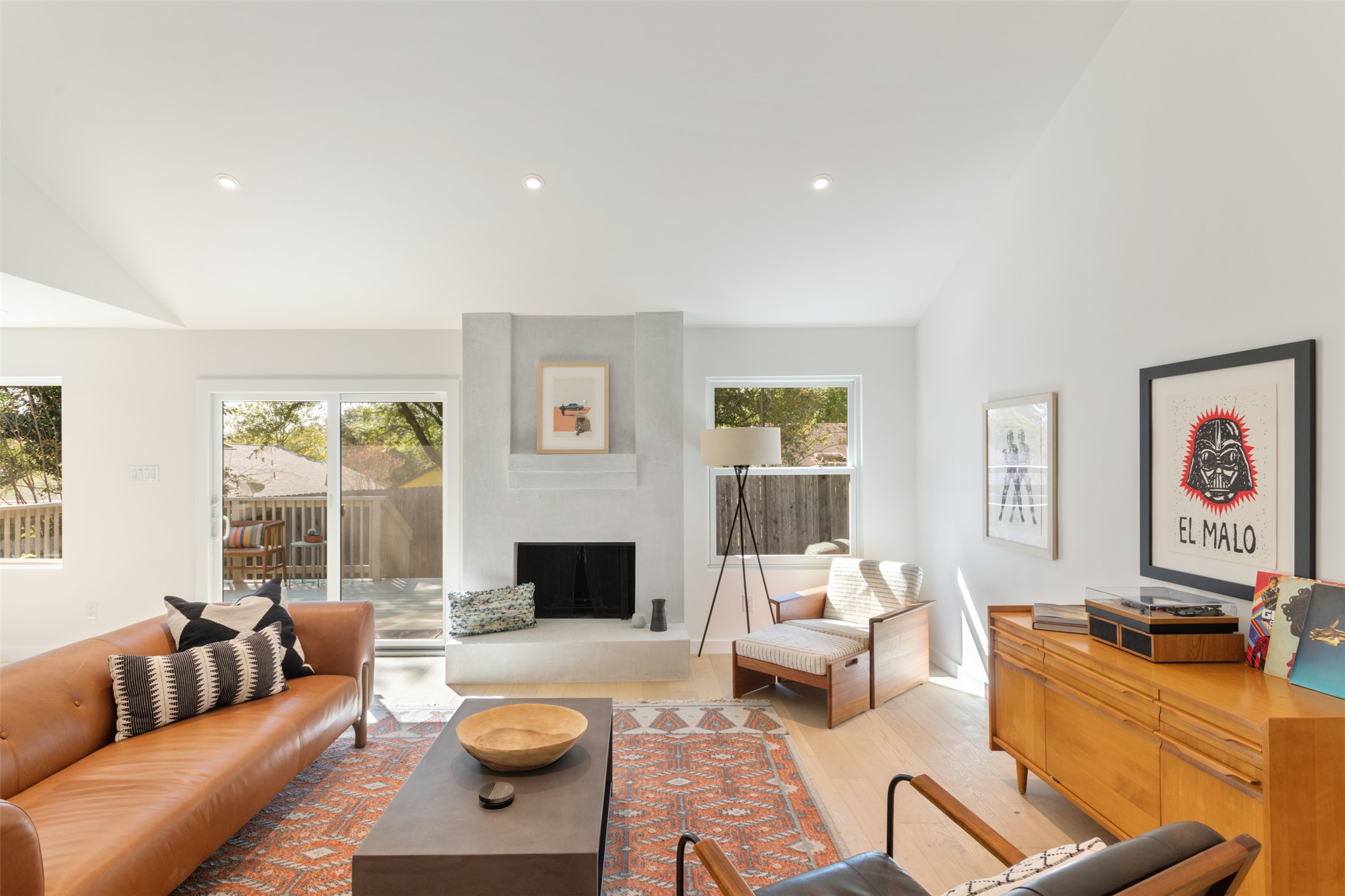 2815 Goldbridge Drive Austin, TX 78745 - Photo 8 of 40 Living room with vaulted ceiling, light wood-style floors, a fireplace, and recessed lighting