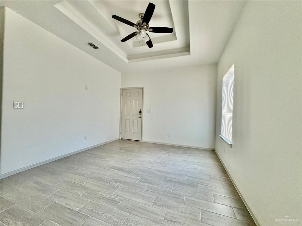 7814 North 58th Street, Unit 3 Mission, TX 78573 - Photo 8 of 11 an empty room with a ceiling fan and window