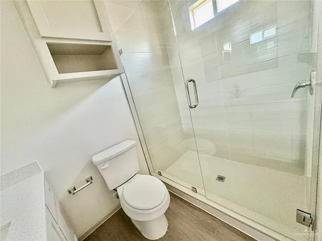 a bathroom with a toilet and a shower