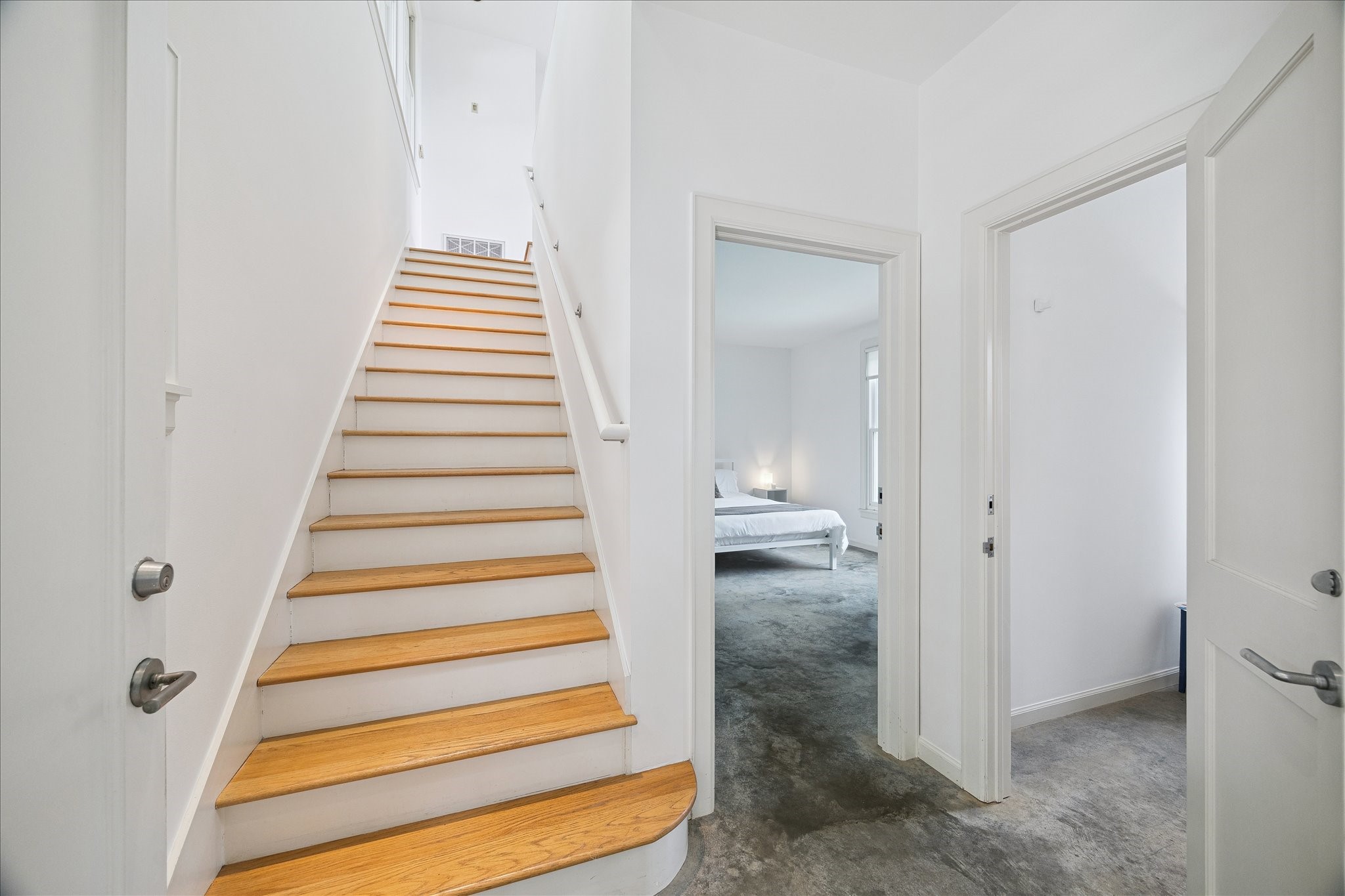 1418 Kipling Street Houston, TX 77006 - Photo 28 of 42 Upon entering into the building facing Kipling street, the stairway leads to the flex space, the doorway leads into the secondary bedroom, and the door to the right leads to the hallway bathroom.