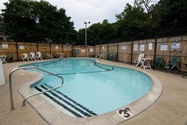 1423 Commonwealth Avenue, Unit 304 Boston, MA 02135 - Photo 5 of 5 a view of a swimming pool with a yard and sitting area