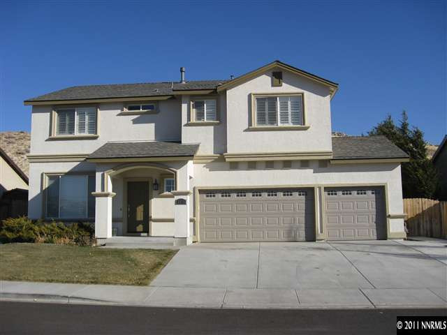 1470 Rainbow Ridge Road Reno, NV 89523 - Photo 1 of 13 a front view of a house with a yard and garage