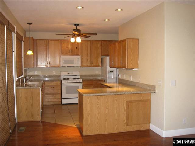 1470 Rainbow Ridge Road Reno, NV 89523 - Photo 5 of 13 a kitchen with a stove a sink and a refrigerator