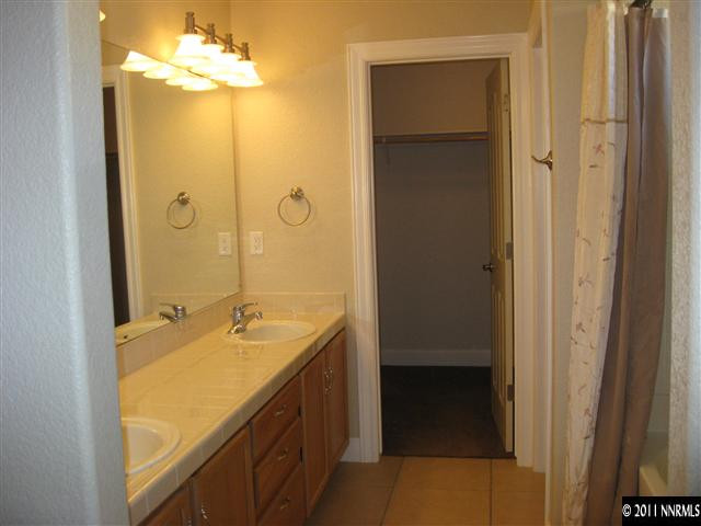 1470 Rainbow Ridge Road Reno, NV 89523 - Photo 10 of 13 a bathroom with a granite countertop sink and a mirror