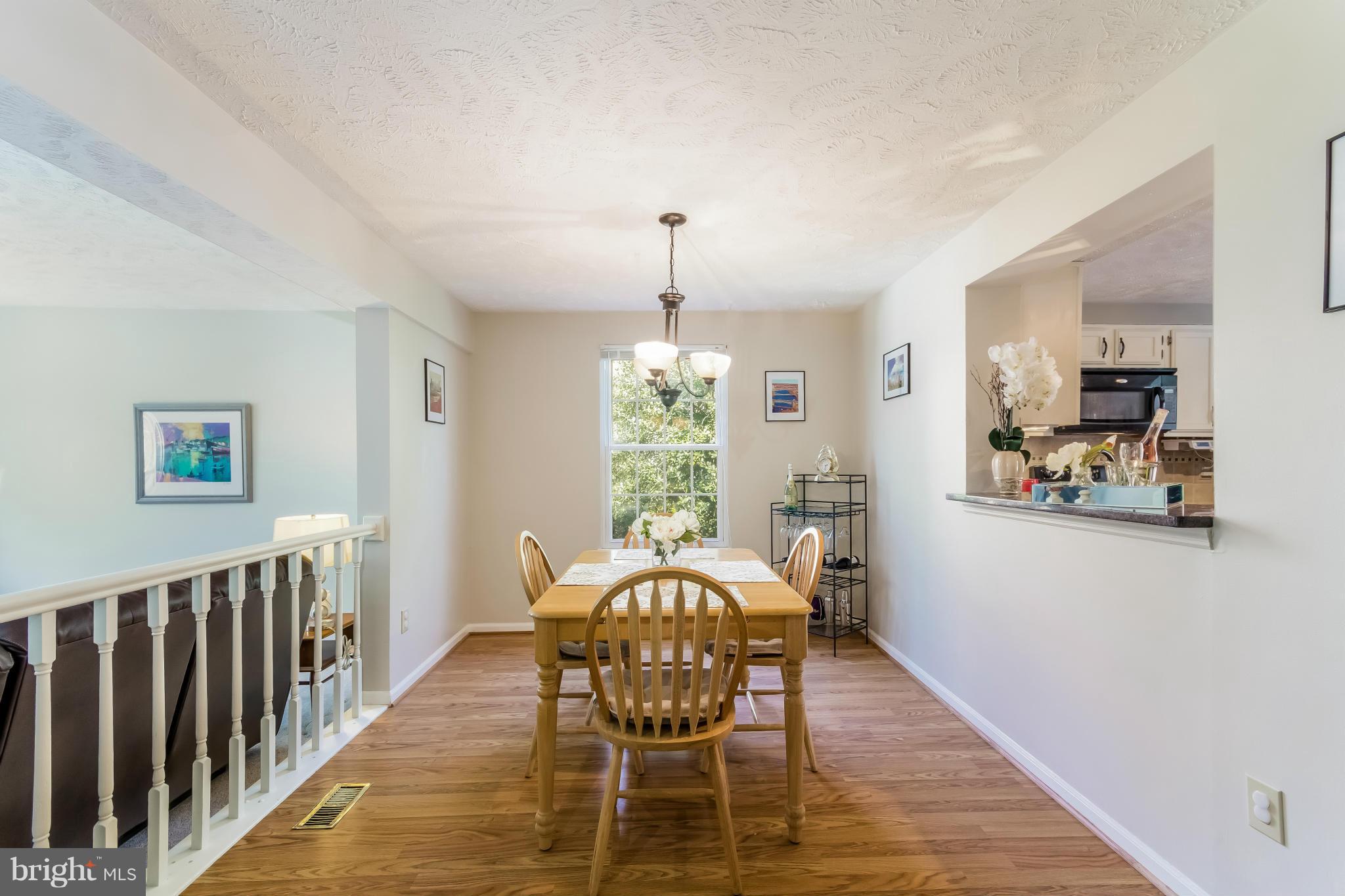 1547 Autumn Ridge Circle Reston, VA 20194 - Photo 11 of 30 a dining room with furniture a window and wooden floor