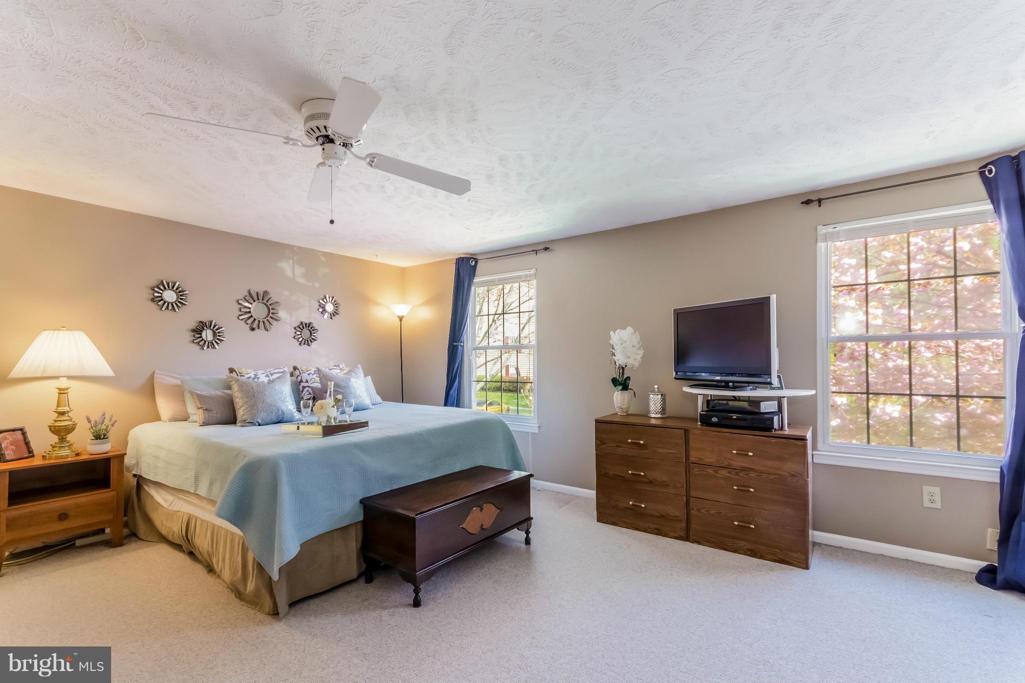 1547 Autumn Ridge Circle Reston, VA 20194 - Photo 16 of 30 a bedroom with a bed and a flat screen tv