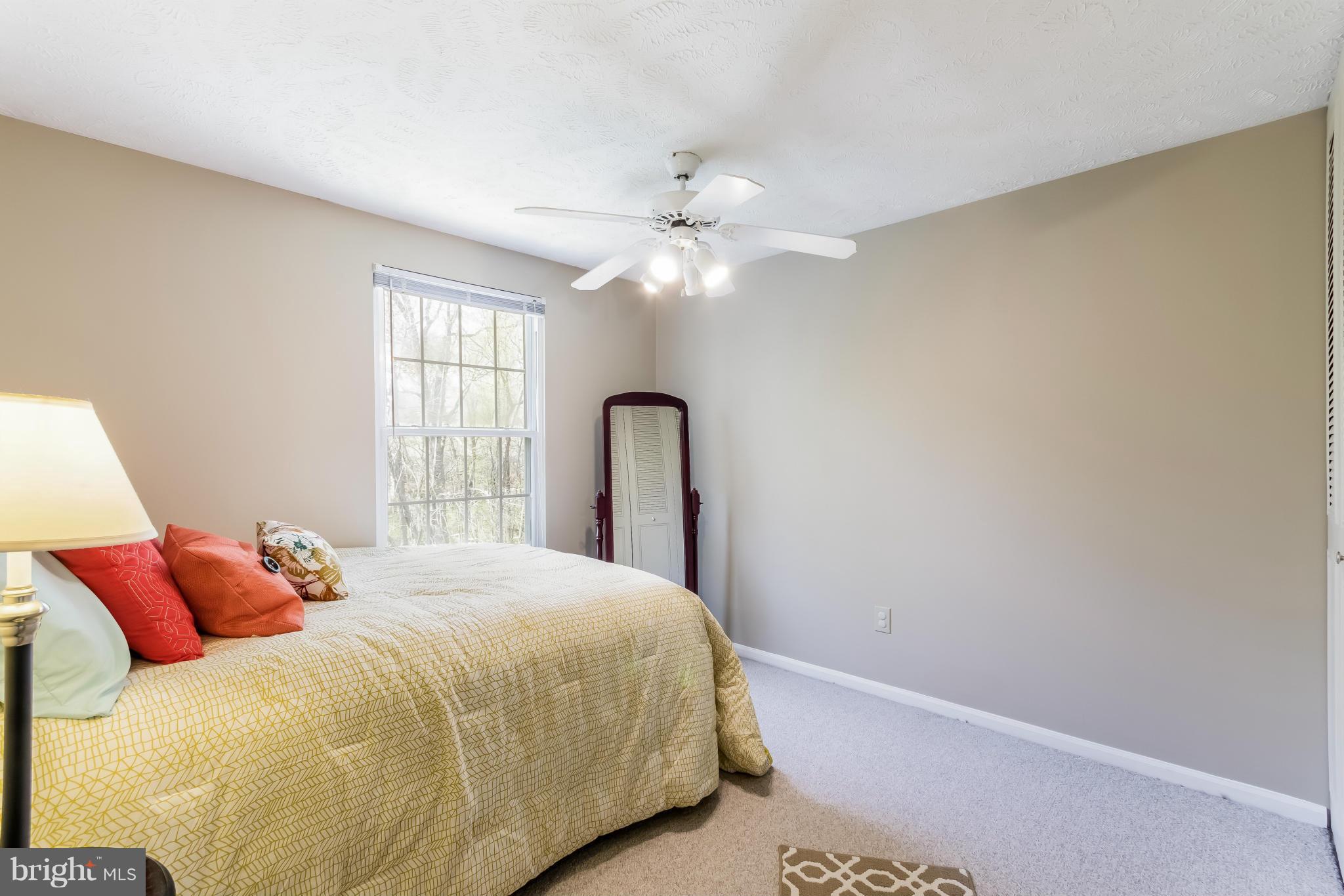 1547 Autumn Ridge Circle Reston, VA 20194 - Photo 21 of 30 a bedroom with a bed and a large window