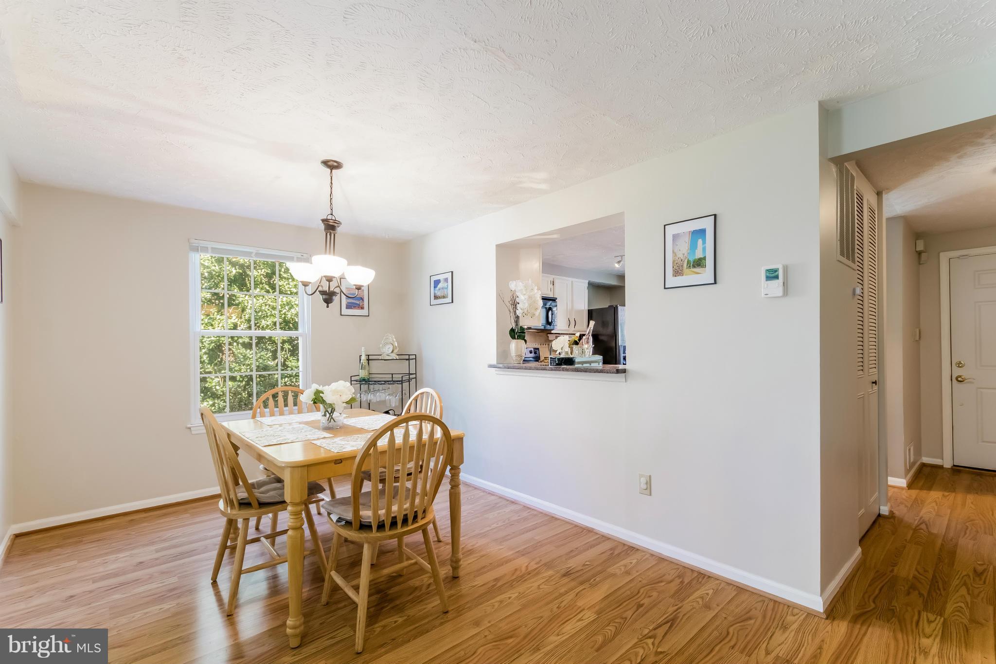 1547 Autumn Ridge Circle Reston, VA 20194 - Photo 9 of 30 a view of a dining room with furniture window and wooden floor