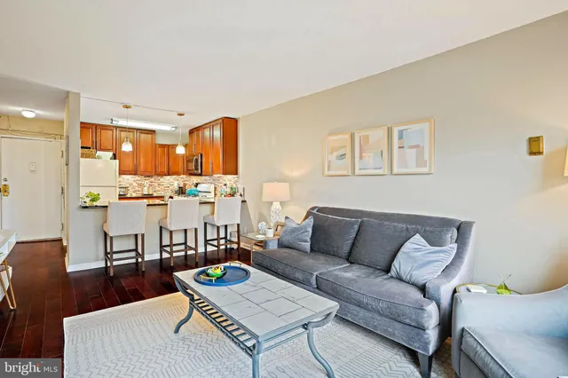 a living room with furniture and kitchen view