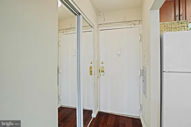 a view of front door with wooden floor