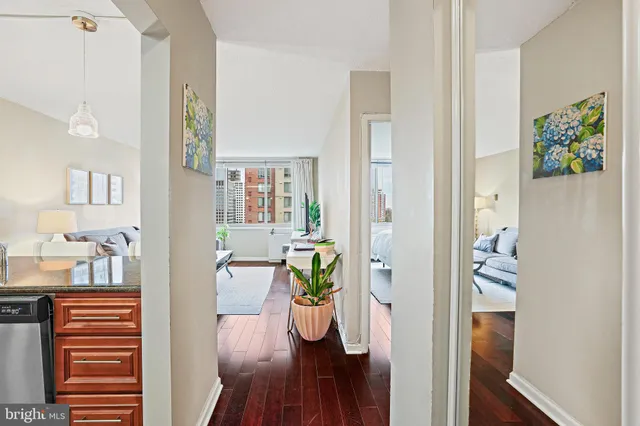 a view of a hallway with wooden floor windows and livingroom