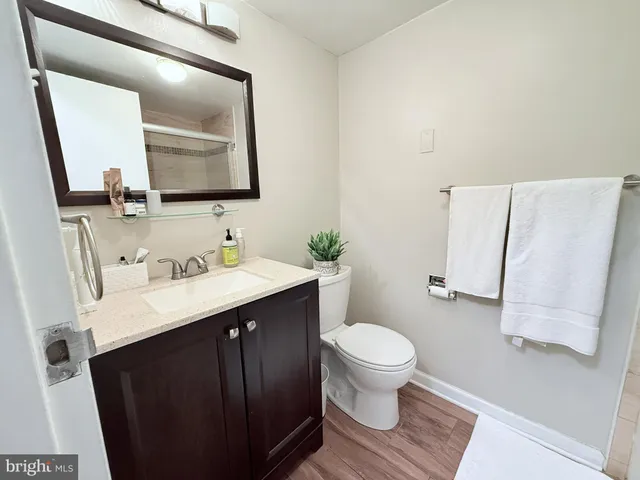 a bathroom with a sink vanity mirror and toilet