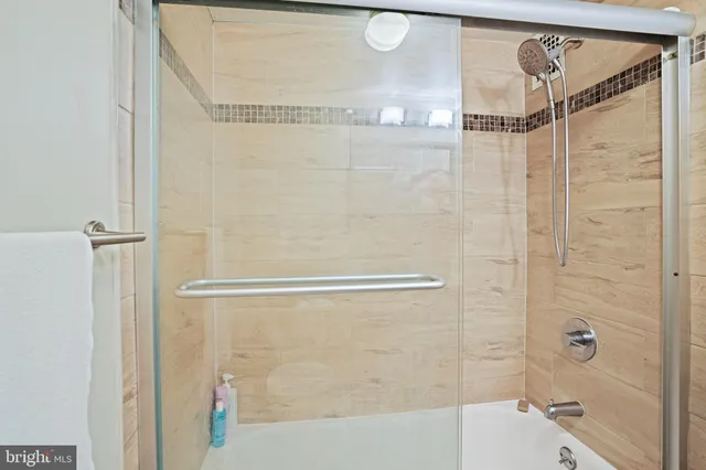 a bedroom with a bed flat screen tv and window