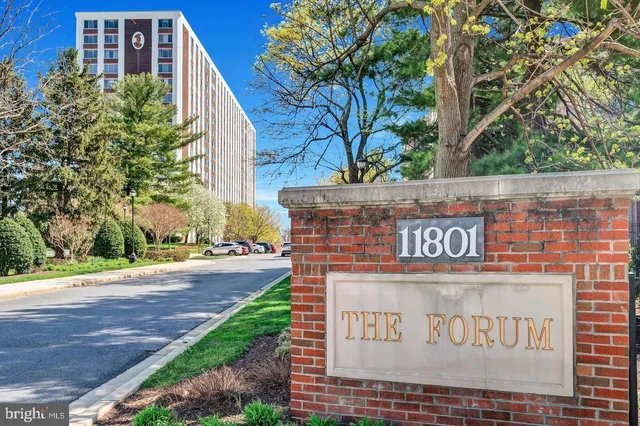 a living room with a bed furniture and a large window