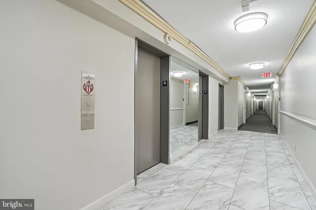 a view of a building with cars parked on the roadside