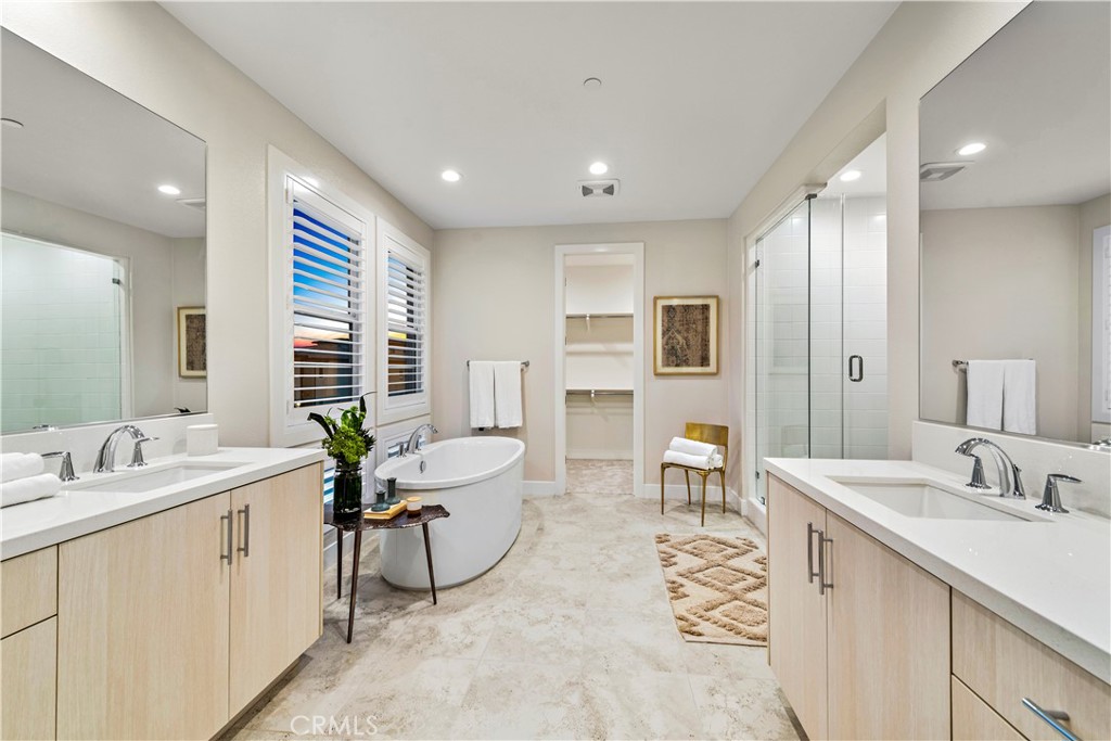 220 Burwood Lake Forest, CA 92630 - Photo 17 of 25 a spacious bathroom with a double vanity sink a large mirror and a shower
