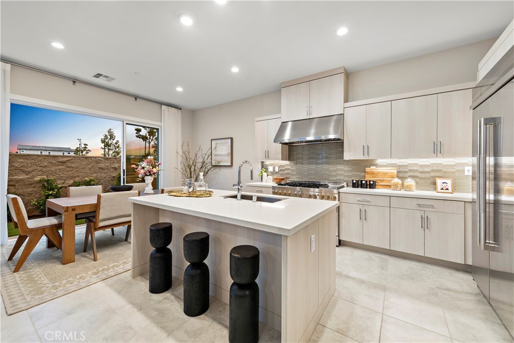 220 Burwood Lake Forest, CA 92630 - Photo 6 of 25 a kitchen that has a lot of cabinets in it with stainless steel appliances granite countertop a stove and a refrigerator