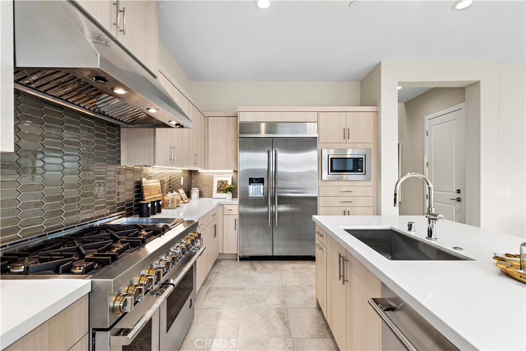 220 Burwood Lake Forest, CA 92630 - Photo 10 of 25 a kitchen that has a sink and stainless steel appliances