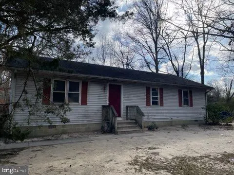 a house that has a tree in front of it